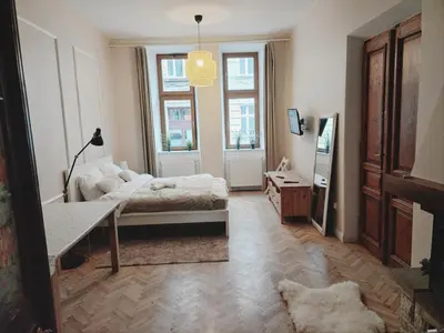 a room with a bed and a table in it at city center 2 rooms 1 kitchen in Kraków