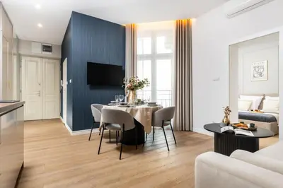a bedroom with a bed and two chairs and a desk at Old Town 5min Main Market Square Perfect Apartment AC WiFi Parking Balcony in Kraków