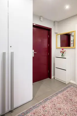 a room with a red door and a rug at Tomasza 25 Apartment 2 in Kraków