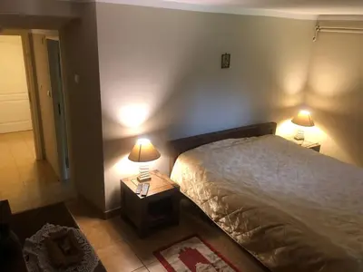 a bedroom with a bed and two lamps on tables at Przytulny pokój z łazienką Cosy Room with Bathroom in Rabka