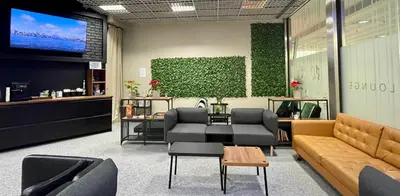 a waiting room with a couch and chairs and a tv at Vistula Lounge - Night Access - Kraków Główny in Kraków