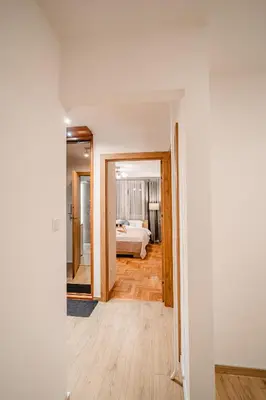 a hallway with a bedroom and a bed in a room at Łagiewniki Apt - 52 m2, Workspace - by Rentujemy in Kraków