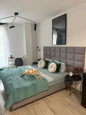 a bedroom with a large bed with pillows on it at Golden Honey Apartment- Studio Cracow Old Town in Kraków