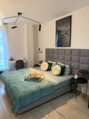 a bedroom with a large bed with a tray on it at Golden Honey Apartment- Studio Cracow Old Town in Kraków
