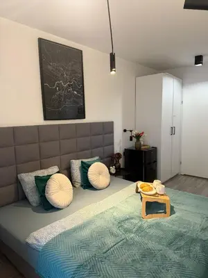 a bedroom with a bed with pillows and a tray on it at Golden Honey Apartment- Studio Cracow Old Town in Kraków
