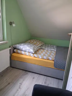 a small bedroom with a bed in a room at Domek u Gosi