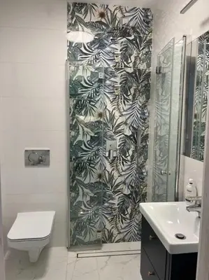 a bathroom with a shower and a toilet and a sink at Domek u Gosi