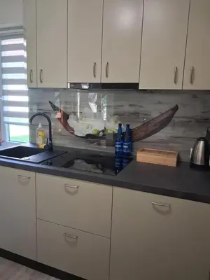 a kitchen with a sink and a counter top with a knife at Domek u Gosi