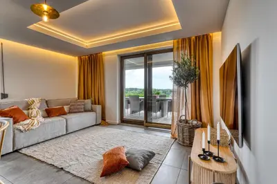 a living room with a couch and a large window at La Nostra Villa in Zator