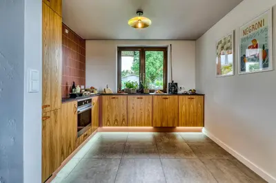 a kitchen with wooden cabinets and a window at La Nostra Villa in Zator
