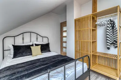 a bedroom with a bed and a wooden shelf at La Nostra Villa in Zator