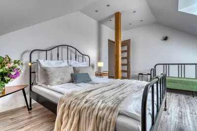 a bedroom with a large bed and a table at La Nostra Villa in Zator