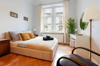 a bedroom with a bed and a large window at Vintage Soul Ariańska in Kraków