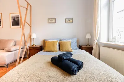 a bedroom with a bed with a robe on it at Vintage Soul Ariańska in Kraków