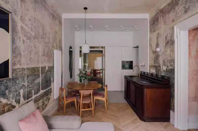 a kitchen and living room with a table and chairs at Imaginibus by MB Apartments in Kraków