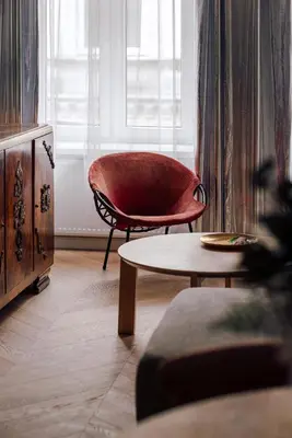 a living room with a chair and a coffee table at Imaginibus by MB Apartments in Kraków