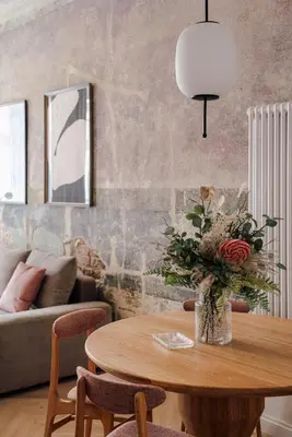 a living room with a table with a vase of flowers at Imaginibus by MB Apartments in Kraków