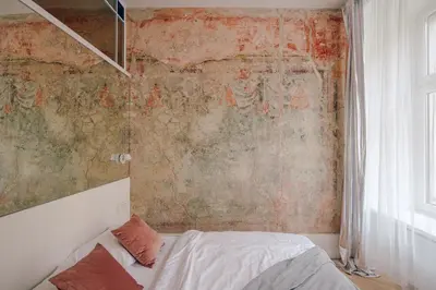a bedroom with a bed and a wall covered in graffiti at Imaginibus by MB Apartments in Kraków