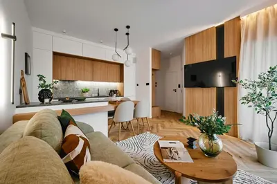 a living room and kitchen with a couch and a table at Verde Dreams Apartment in Kraków