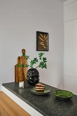 a table with a piece of cake and a plate at Verde Dreams Apartment in Kraków