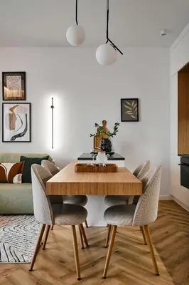 a dining room with a wooden table and chairs at Verde Dreams Apartment in Kraków