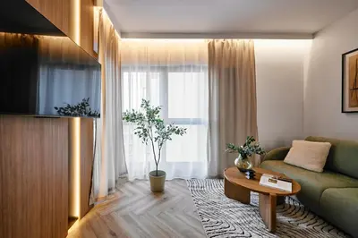 a living room with a couch and a table at Verde Dreams Apartment in Kraków