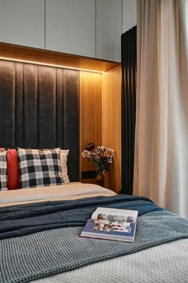 a bedroom with a bed with a book on it at Verde Dreams Apartment in Kraków