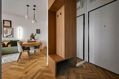 a small apartment with a dining room table and a kitchen at Verde Dreams Apartment in Kraków