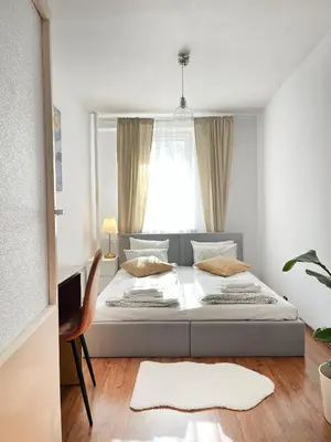 a bedroom with a large bed with a window at Apartment for 7 guests in the city of Cracow in Kraków