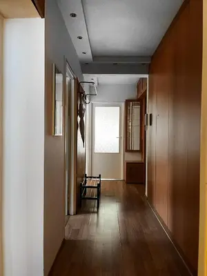 a hallway with a chair in a room at Apartment for 7 guests in the city of Cracow in Kraków