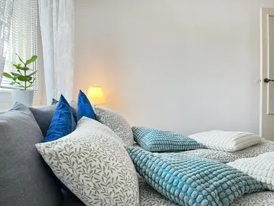 a bunch of pillows sitting on a couch at Apartment for 7 guests in the city of Cracow in Kraków