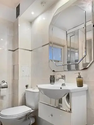 a bathroom with a sink and a toilet and a mirror at Apartment for 7 guests in the city of Cracow in Kraków