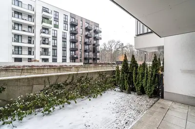 a row of christmas trees in front of a building at RentPlanet - Apartament Rakowicka in Kraków