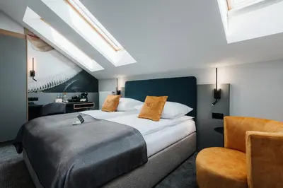 a room with a desk with a tv on a wall at Hotel M4 Boutique in Kraków