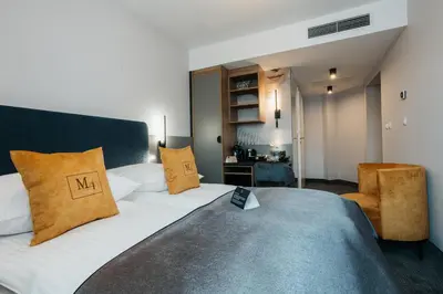 a dining room with a table and chairs and mirrors at Hotel M4 Boutique in Kraków