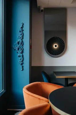 a dining room with tables and chairs and mirrors at Hotel M4 Boutique in Kraków