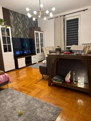 a living room with a couch and a television at The Nest, Apartament in Oświęcim
