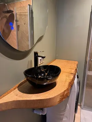 a bathroom with a black sink and a mirror at The Nest, Apartament in Oświęcim