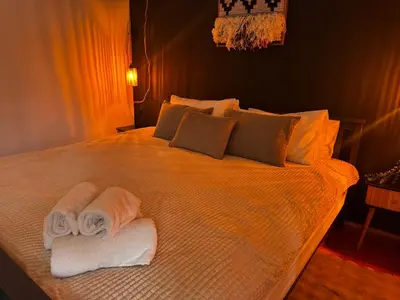 a bedroom with a bed with towels on it at The Nest, Apartament in Oświęcim