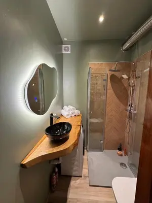 a bathroom with a sink and a shower at The Nest, Apartament in Oświęcim