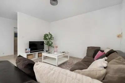 a living room with a couch and a table at Bright Apartment in Kraków Perfect for Remote Work by Noclegi Renters in Kraków