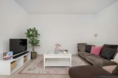 a living room with a couch and a tv at Bright Apartment in Kraków Perfect for Remote Work by Noclegi Renters in Kraków