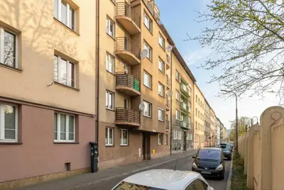 a street with cars parked next to a building at Bright Apartment in Kraków Perfect for Remote Work by Noclegi Renters in Kraków