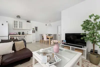 a living room with a couch and a table at Bright Apartment in Kraków Perfect for Remote Work by Noclegi Renters in Kraków