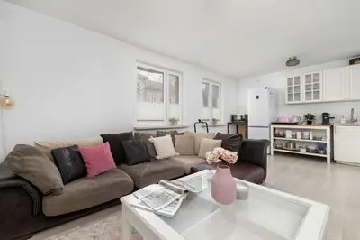 a living room with a couch and a table at Bright Apartment in Kraków Perfect for Remote Work by Noclegi Renters in Kraków