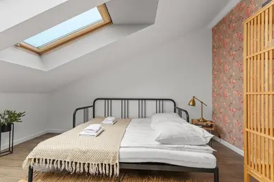 a bedroom with a bed and a window at Parkside Design Loft in Kraków
