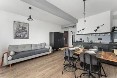 a living room with a couch and a table at Parkside Design Loft in Kraków