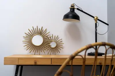 a desk with a lamp and a mirror on it at Parkside Design Loft in Kraków