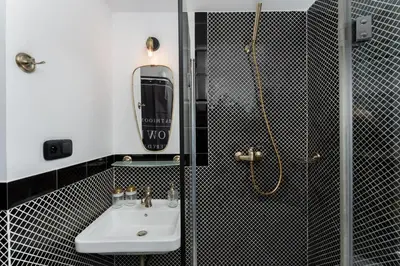 a bathroom with a sink and a mirror and a shower at Parkside Design Loft in Kraków