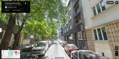 a street with cars parked on the side of the road at Parkside Design Loft in Kraków